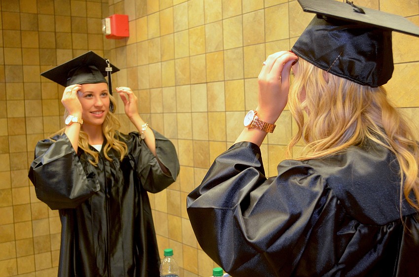 Bailey Reiter finishes getting her graduation outfit ready.