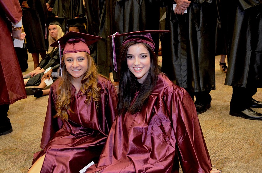 Gabby Stockton and Marisa Turner relax on the floor and take a break from wearing their high heels.