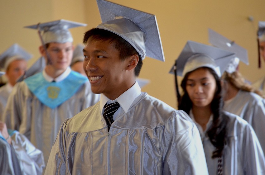 Howie Tan walks toward the auditorium where he will graduate.