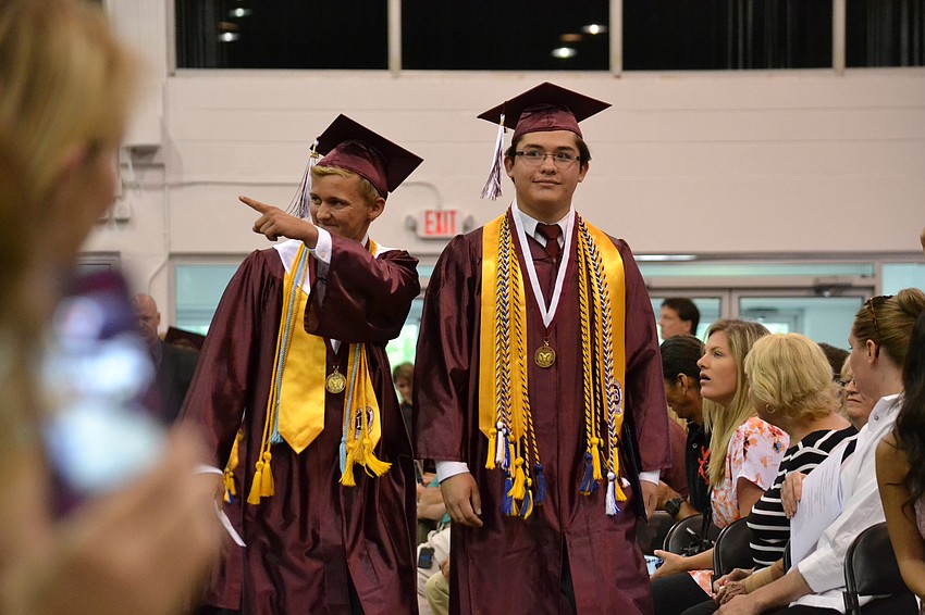 Students wave to family and friends as they enter Robarts Arena.