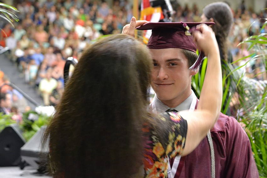 Jarred Carr has his tassel moved from right to left.