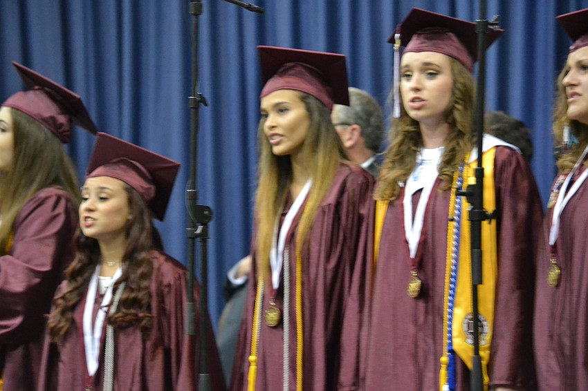 Students perform the national anthem to start the commencement ceremony.