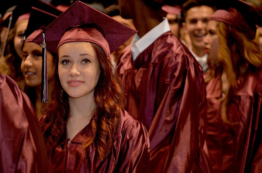 Kennedy Kovalick enjoys the senior video before the graduation speakers start their presentations.