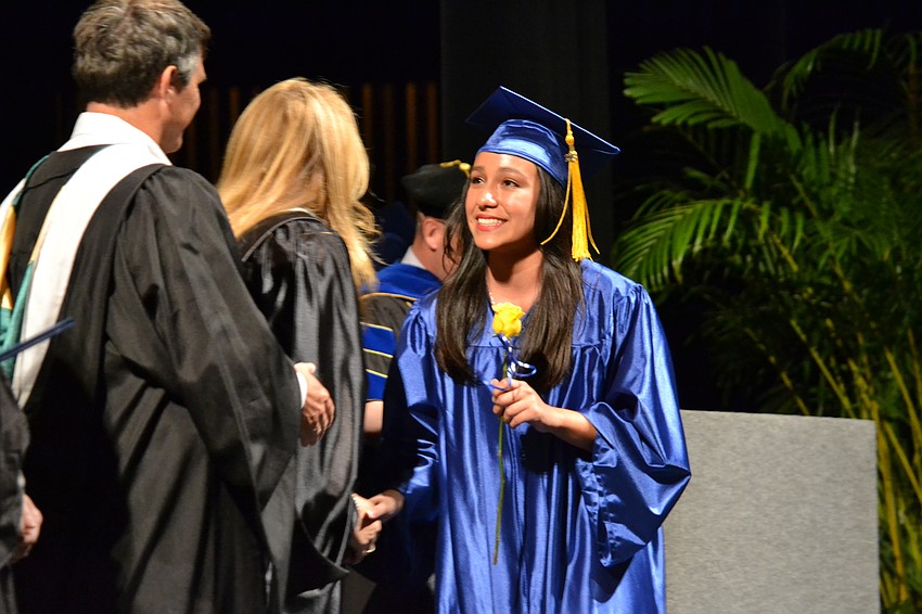 Angie Aramayo is greeted by senior class sponsor Lori Moyer.