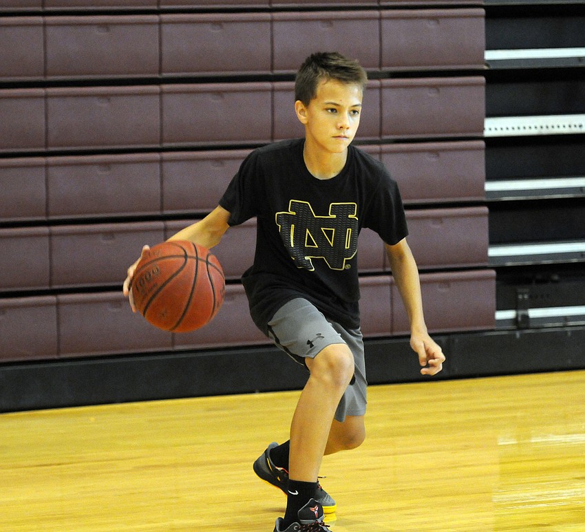 Thirteen-year-old Connor Powers completes a series of ball handling drills.