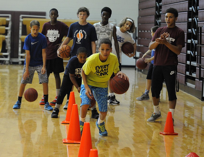 Ryker Swor, 12, maneuvers through a series of cones during a ball handling drill.