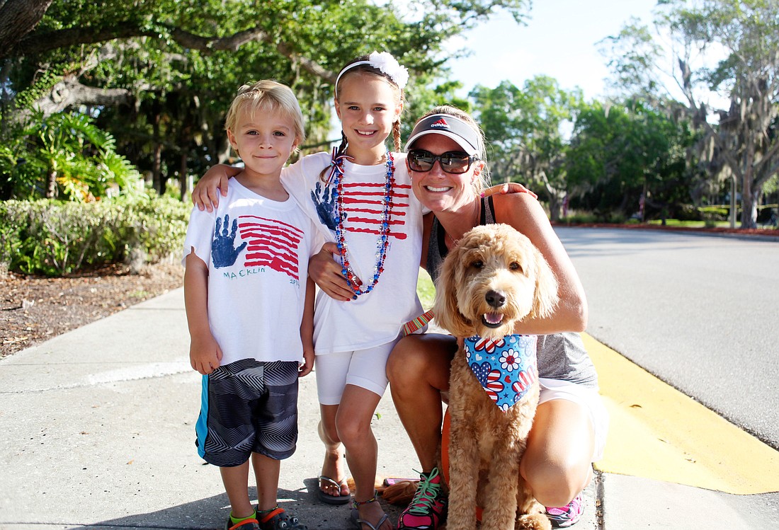 Macklin and Callie Higgins smile next to their mother, Lisa, and their pup, Mango, at last year's Freedom Fest.