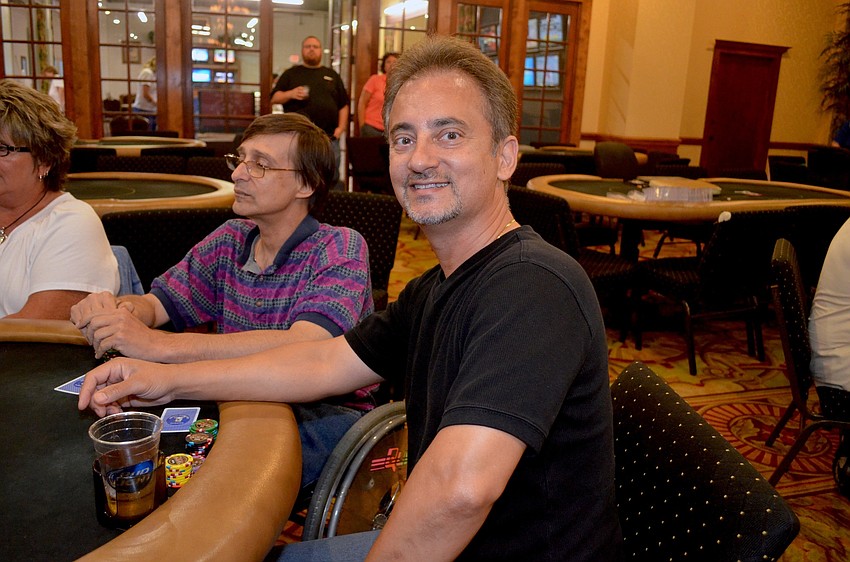 Tom Kouvastos takes his chances during an early round of poker.