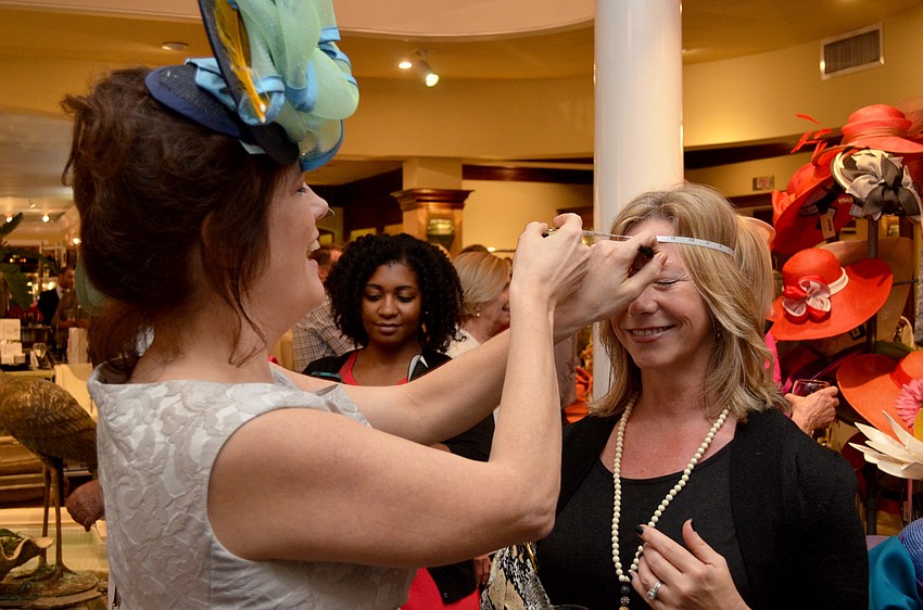 Christine A. Moore measures Rebekah Parker for a hat.