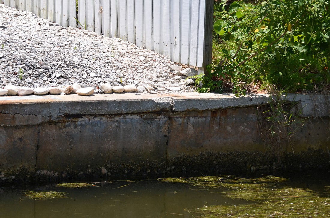 A dilapidated seawall that needs repairs at 759 St. Judes Drive N. has caused a rift between the Town Commission and its code board. Photo by Kurt Schultheis