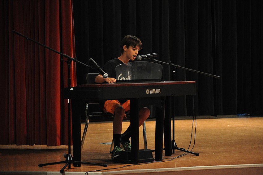 Frank Runge sings and plays Rush’s “Tom Sawyer.”