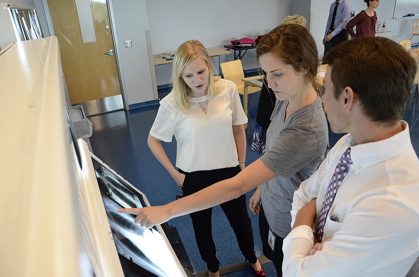 LECOM students Kelli Fox, Lauren Solomon and Jacob Howard quiz each other on the x-ray slides.