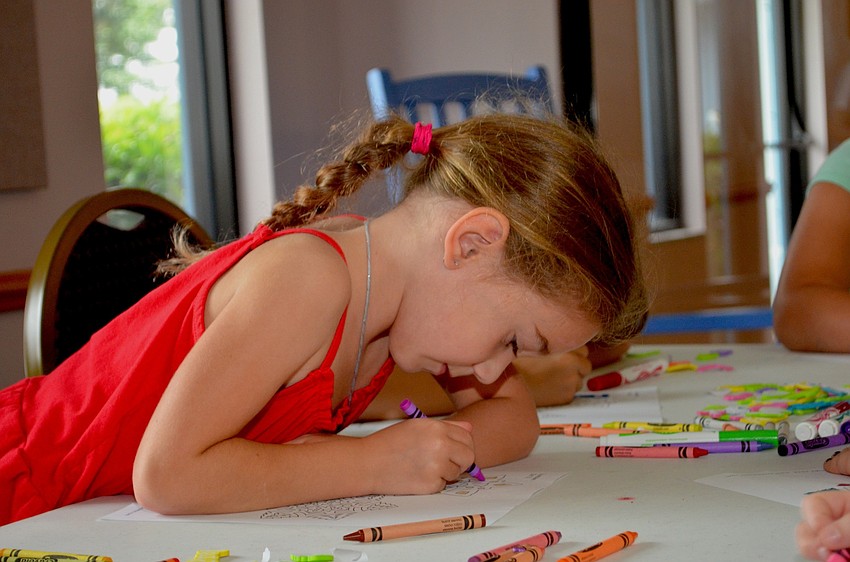Christina Springfield focuses on coloring in a flower.