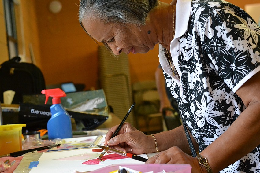 Doriel Rock Boyce works near the window for lighting on her piece.