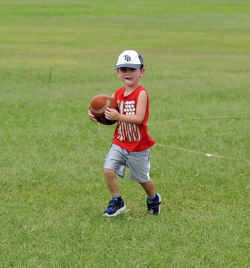 Four-year-old Cooper Mulder races for the end zone after recovering a fumble.