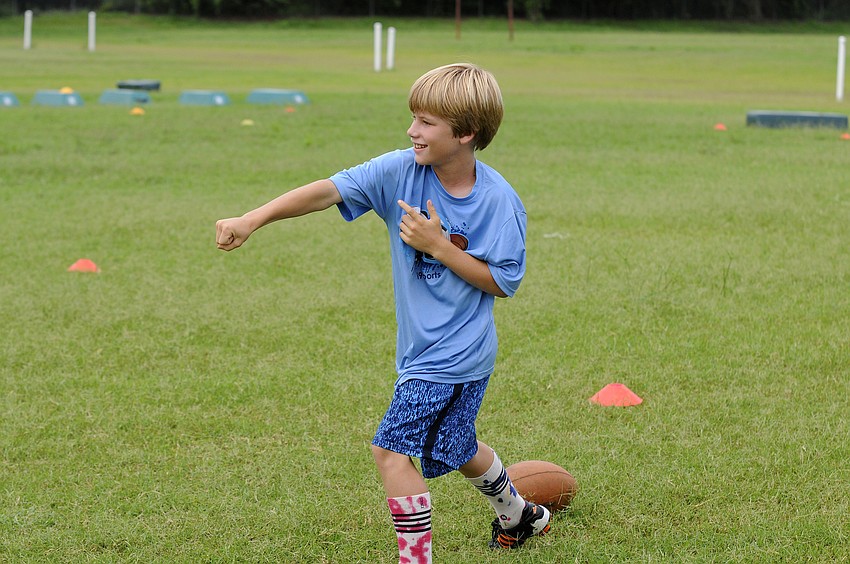 Nine-year-old Tanner Hall celebrates after recovering a fumble for a touchdown.