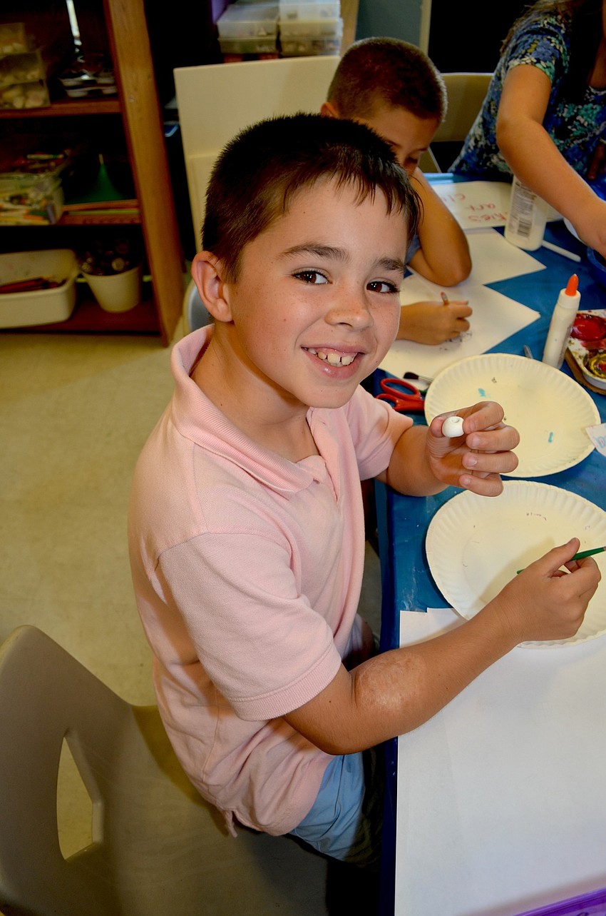 Harrison Molesky crafts a bug from a ball of clay.