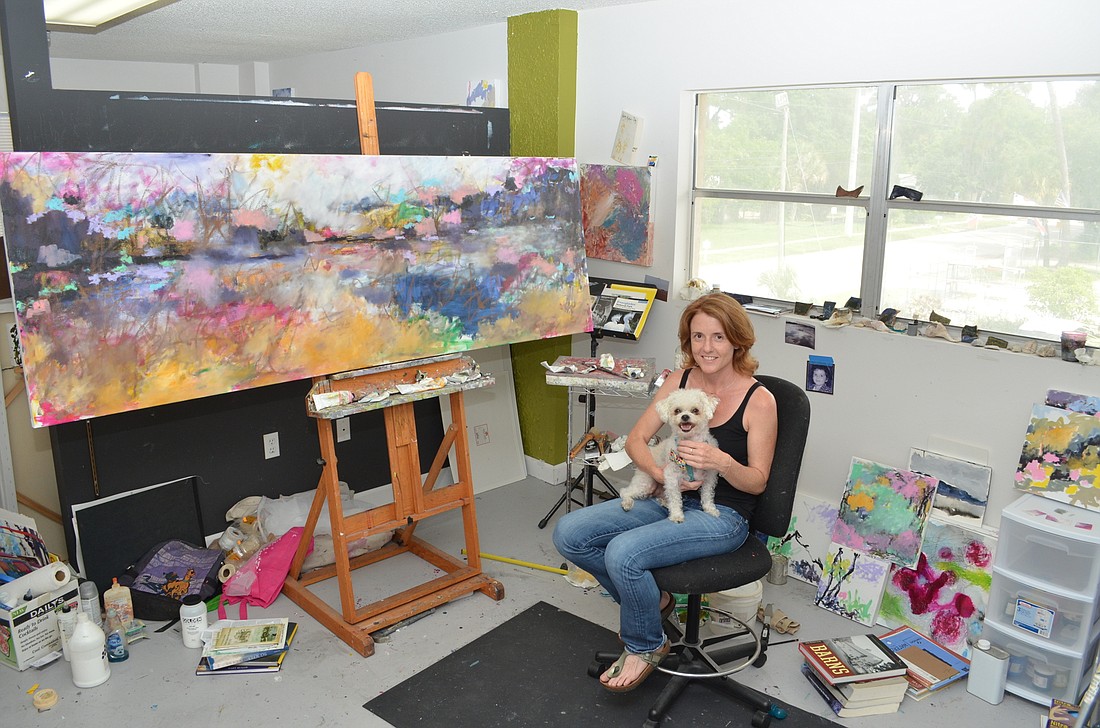 Kathy Wright with her rescue dog Noodle in the spacious Central Avenue art studio.