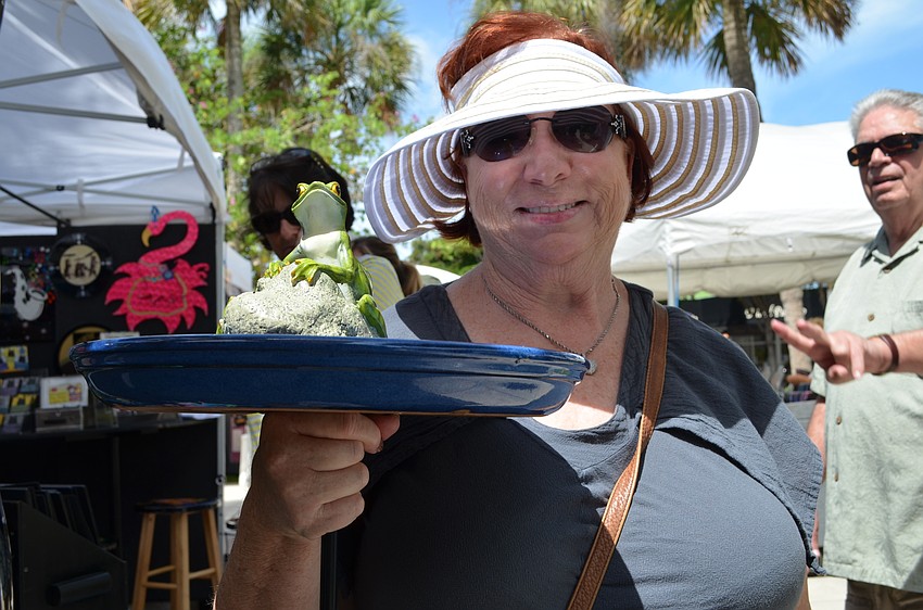 Edie Nemo shows off her purchase of a birdbath.