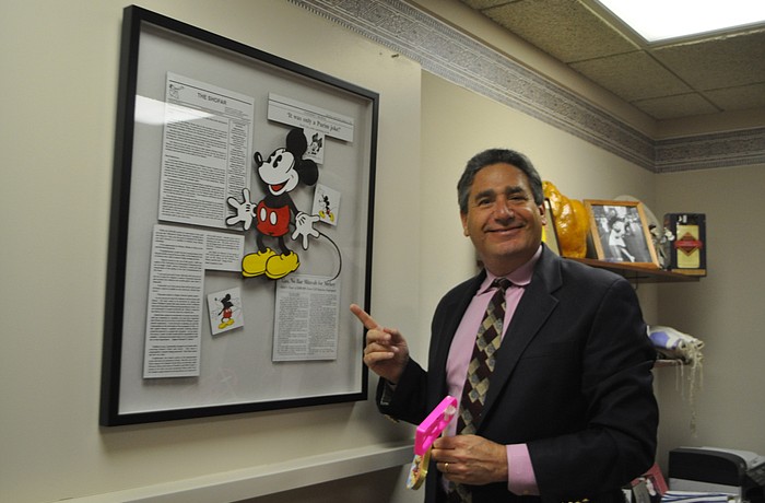 Robin Hartill Temple Beth Israel Rabbi Jonathan Katz points to news stories about his infamous 1994 Disney-themed Purimspiel that included Mickey Mouse appearances at bar mitzvahs.