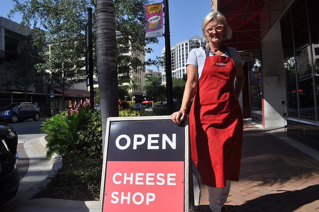 Louise Kennedy Converse, owner of Artisan Cheese Co., is hopeful the city will establish new regulations allowing for the use of A-frame signs like the one outside her store.