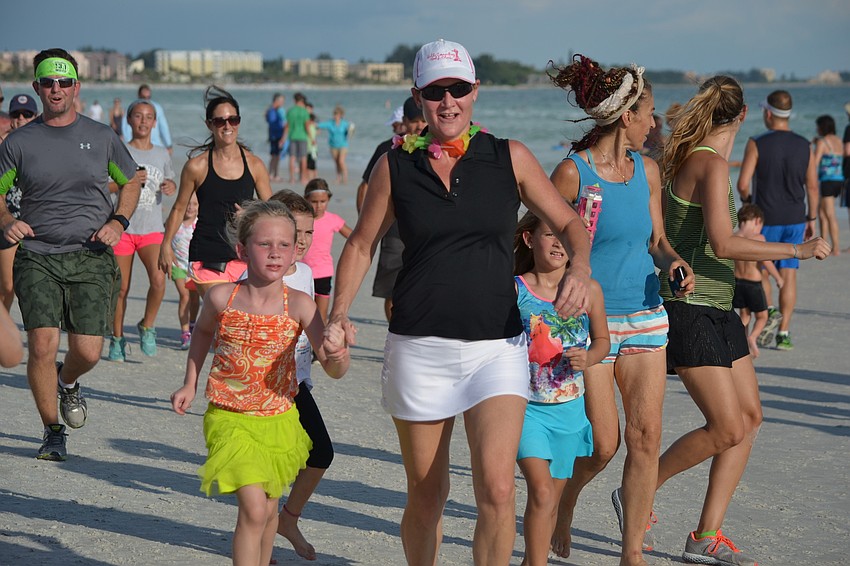Children and parents participated together in the Siesta Summer Beach Run Tuesday, June 16.