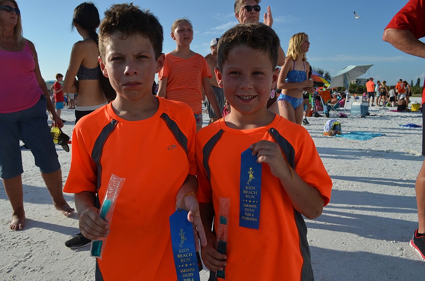 Jake and Grey Dawes with their ribbons and ice pops after the run.