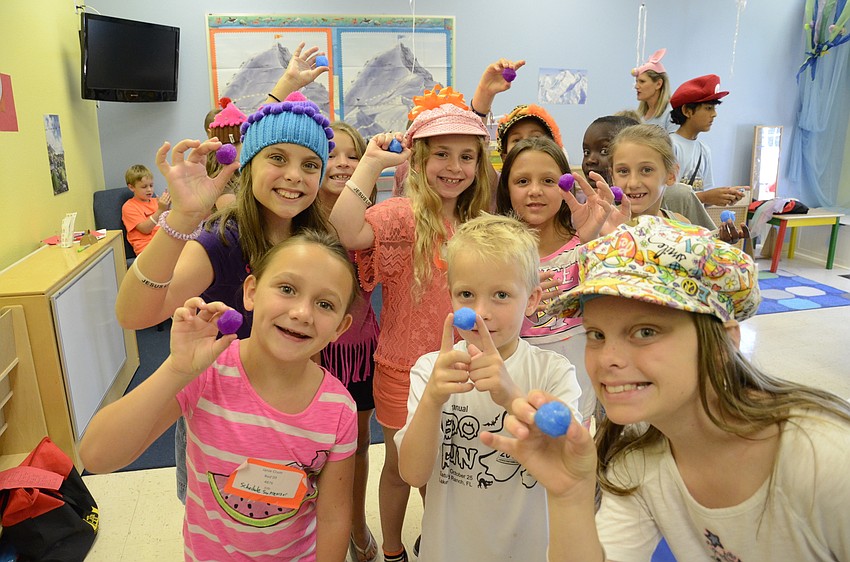 A VBS class shows off their homemade bouncy balls.