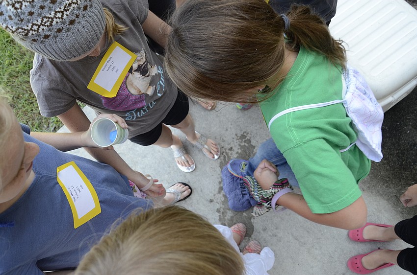 Students try to loosen up a frozen t-shirt, an exercise designed to demonstrate patience.