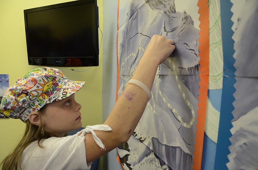 Chloe Jarvis, 11, posts a footprint to the mountain board.
