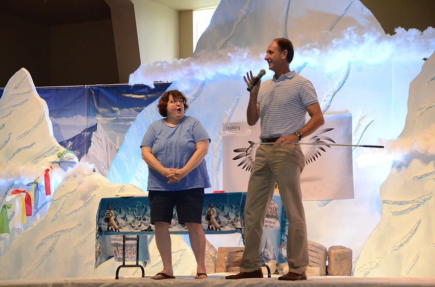 Children's minister Connie Campbell and Co-Pastor Steve Price talk to the students about the VBS's fundraising goal.