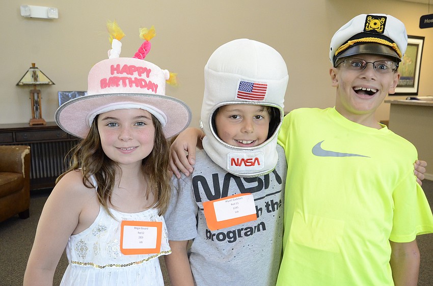Megan Bovaird, 9, Wyatt Gadeken, 8, and Alex den Boggende, 9, wore their craziest hats.