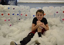 Tyler Perkins, 11, pretends to be cold in the igloo.