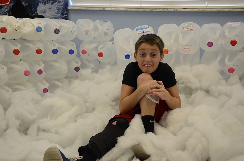 Tyler Perkins, 11, pretends to be cold in the igloo.