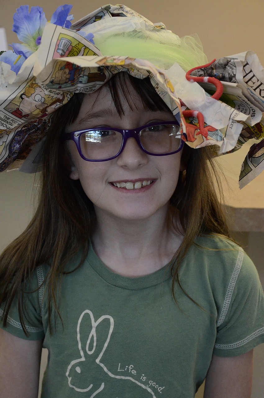 Virginia Frisbie, who turns 8 on Saturday, sported a news-print bonnet for crazy hat day.