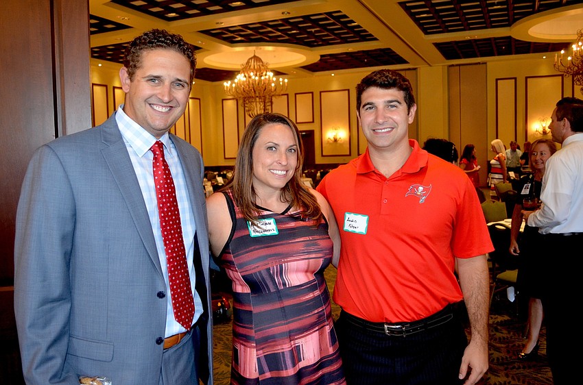 Tampa Bay Buccaneers representatives Chris Spano, Amy Saxon and Austin Fetzer sow support for their NFL team.