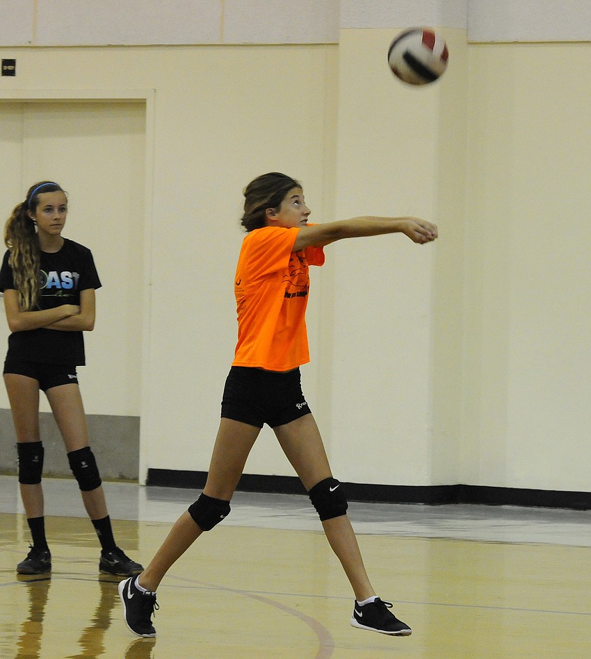 Malia Tomasso passes the ball back to a teammate.