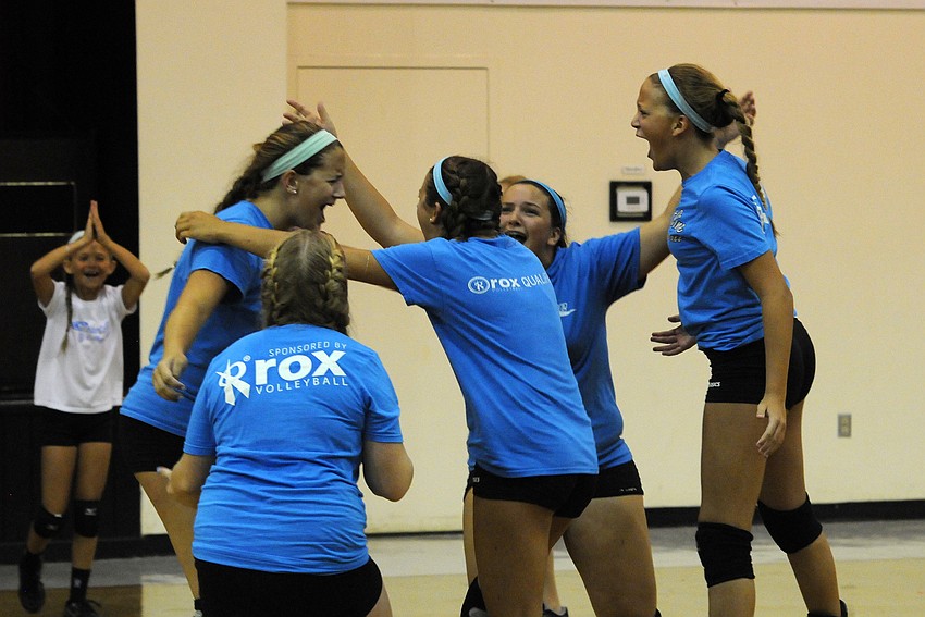 A group of Coastline Volleyball Club players celebrate a point during Cardinal Mooney’s volleyball camp June 11.