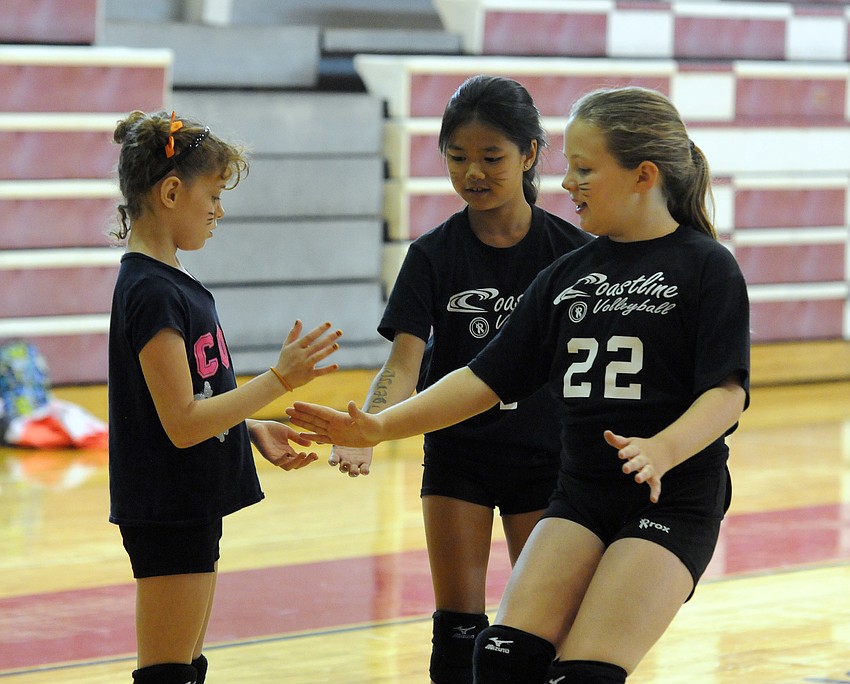 Teammates Sadie Morehead, Kayli Littlejohn and Ella Pardue celebrate a point during their team competition.