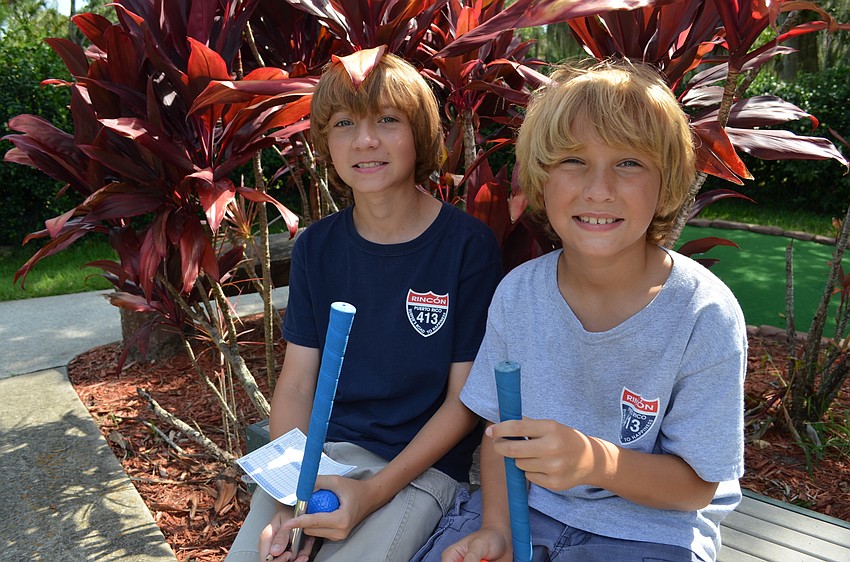 Dylan and Ashton Morrell take a break between holes.