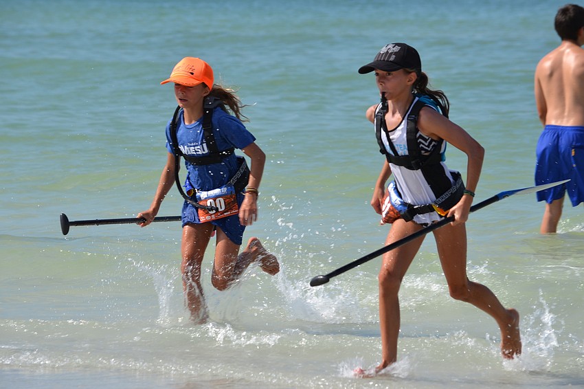 Ashley and Gracie Marston make their way on to the beach to complete a lap in the 5K course.