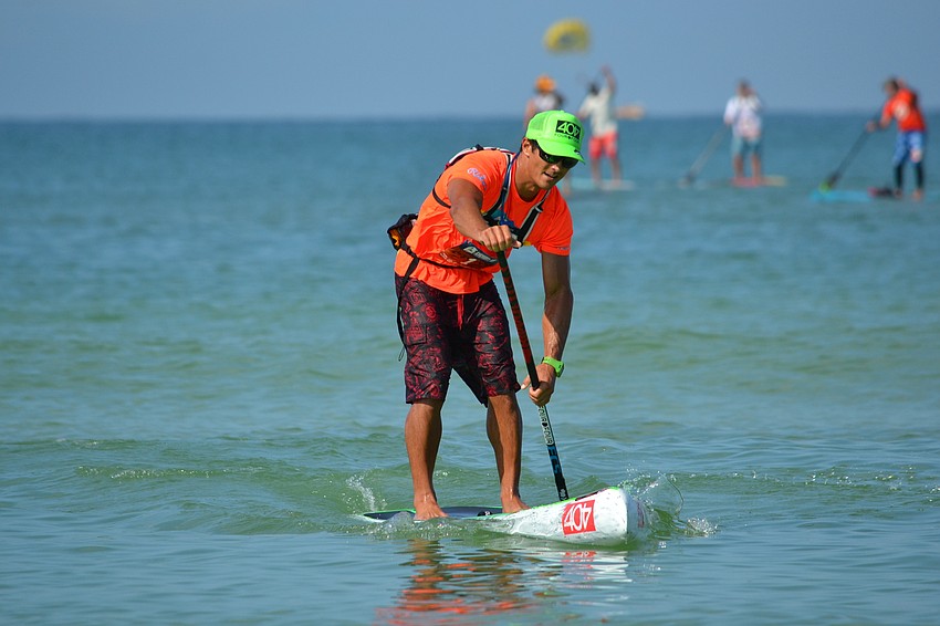 10K Overall winner Danny Ching paddles along the course.