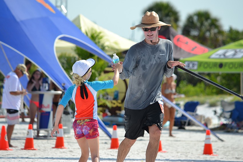 Fritz Wermuth grabs a water bottle during the first lap.