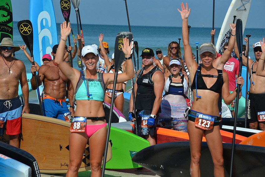 Katherine Pyne and Kate Pagan wave during a pre-race group photo.