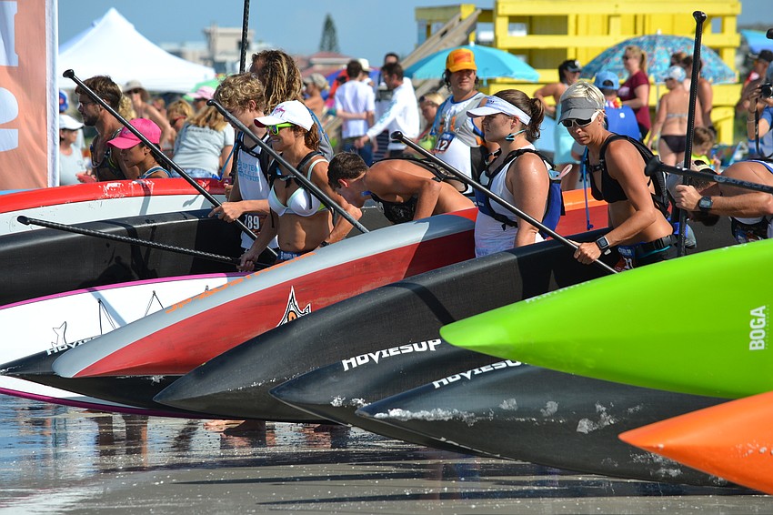 Racers at the starting line before running into the waters.