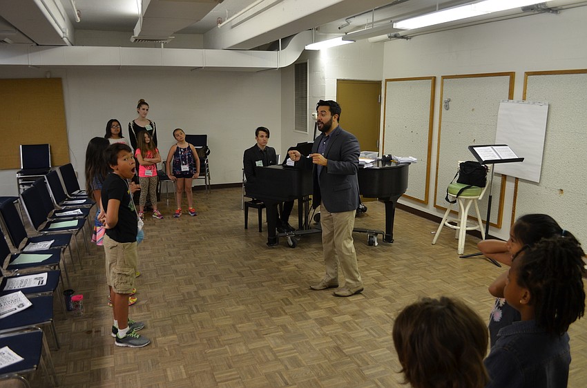Maestro Jesse Martins begins the morning's class with staggered rendition of a youth opera song.