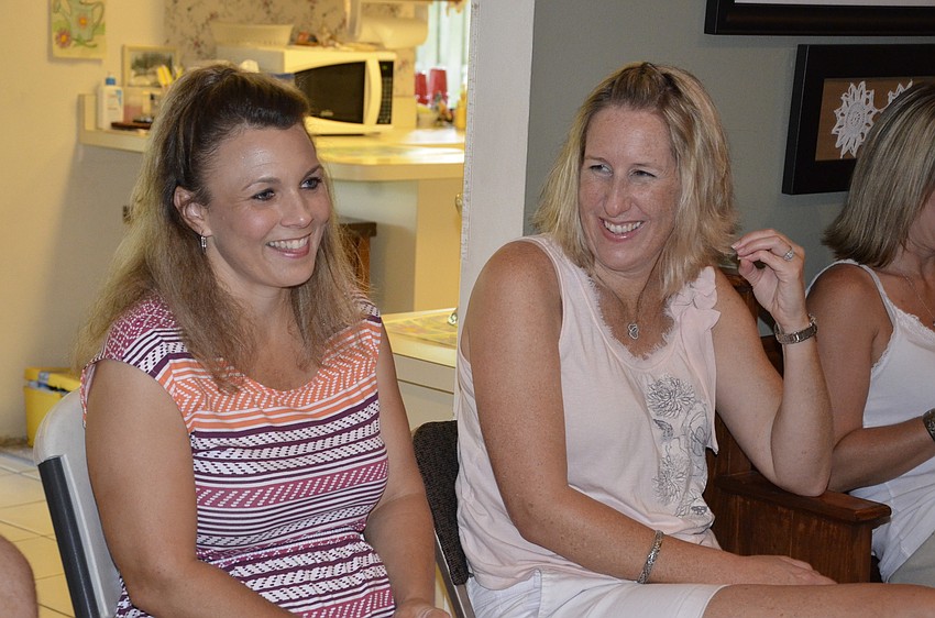 Cousins Amy Corkin and Kisha Hollifield laugh during grandmother Betty Hollfield's performance.