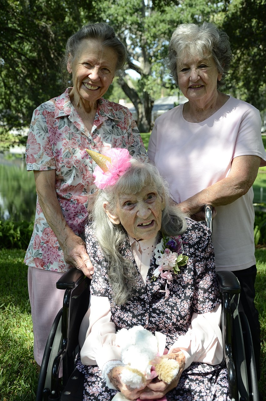 Betty Hollifield and Wilma Ellison with their mother, Edna Strode, who turned 100 June 15.