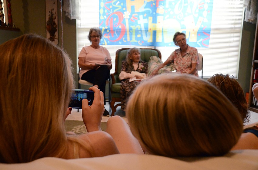 Edna Strode's great-great granddaughters record Strode's daughter's performance.