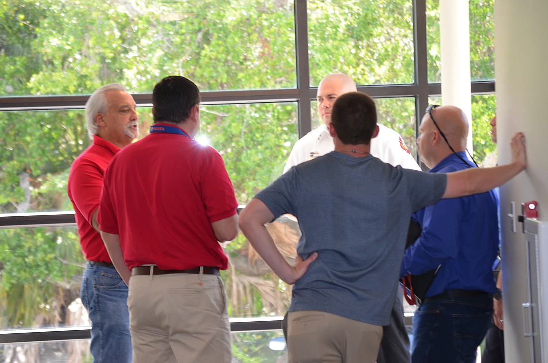 The Longboat Key Fire Rescue Union  negotiation team confers in the hallway at Town Hall June 16 when the townâ€™s negotiation team asked for a few minutes to discuss their presentation alone.